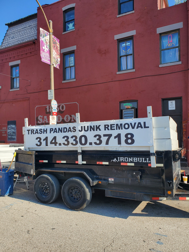 A junk removal trailer for Trash Pandas llc - JUNK Removal, parked on a street in St. Charles, MO, ready for service.