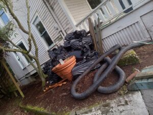An overhead view of a junk removal truck and a large pile of wooden debris on the ground at an apartment complex, handled by JUNK IN THEE TRUNK in Kent, WA.