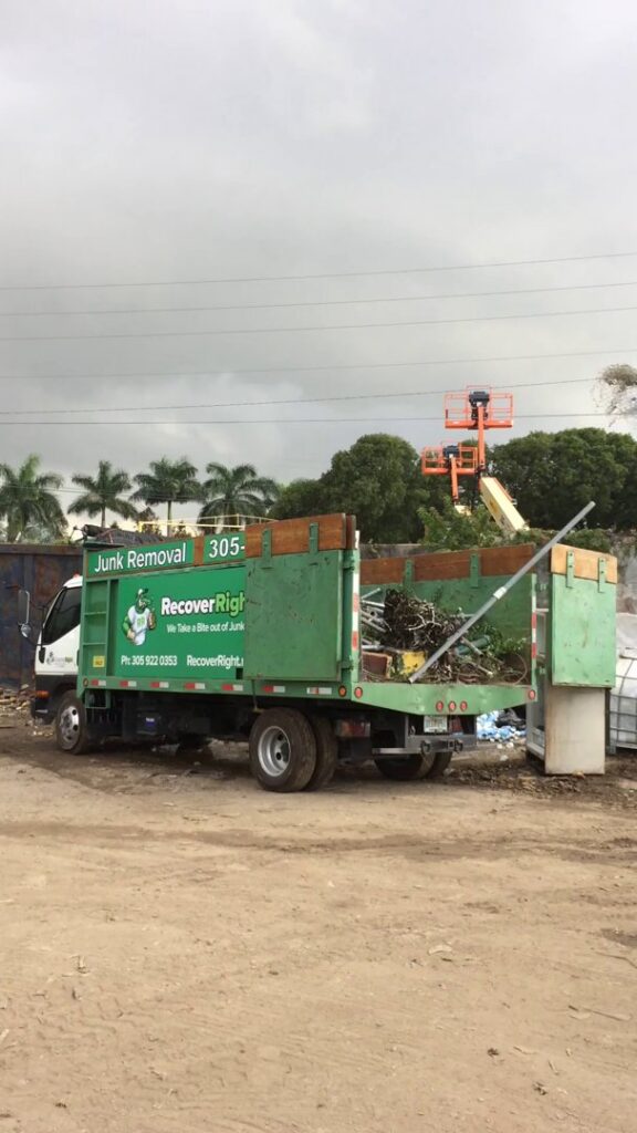 A junk removal truck filled with green waste and debris after a successful cleanout by Gator Junk Removal in Miami, FL.