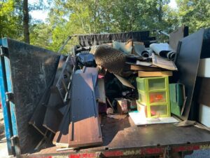 A Black Diamond Junk Removal truck completely full of various household junk items in Bedford Heights, OH.