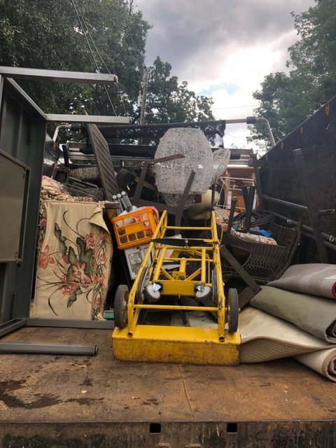 A G.I.HAUL ATLANTA junk removal truck filled with various items, including furniture and rugs, in Atlanta, GA.