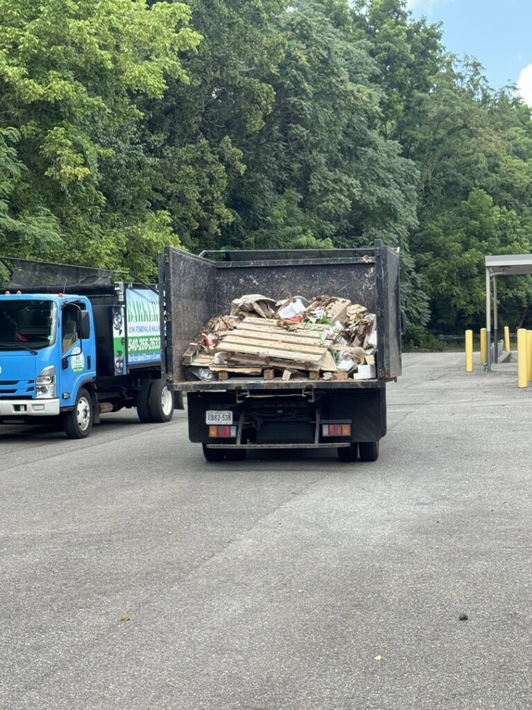 A Barkers Junk Removal & Hauling LLC truck filled with debris after a job in Roanoke, VA.