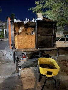 A Tidy Toss junk removal truck loaded with various items at night after a job in Las Vegas, NV
