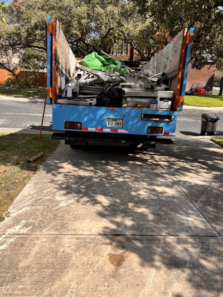 A junk removal truck loaded with various debris, including metal and wood, after a job by SATX Junk-A-Haulics in San Antonio, TX.