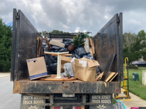 A G.I.HAUL ATLANTA junk removal truck loaded with various household items and debris in Atlanta, GA.