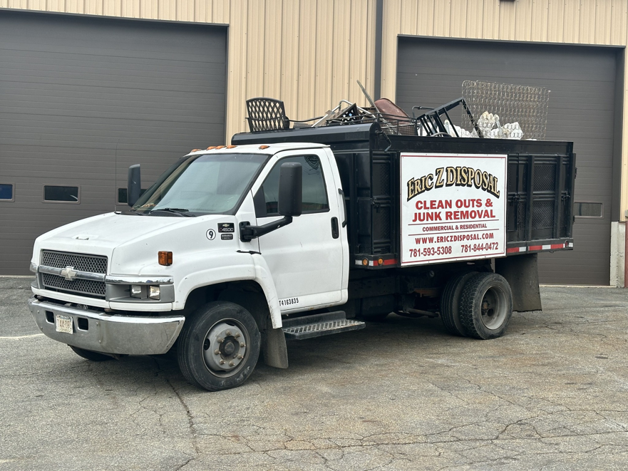A white junk removal truck loaded with various items, ready for disposal by Robert Z Disposal in Lynn, MA.