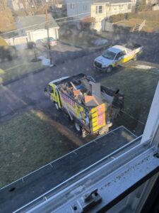 A Junken Monkeys Hauling Company truck loaded with various debris and junk, seen from above during a removal job in Scranton, PA.