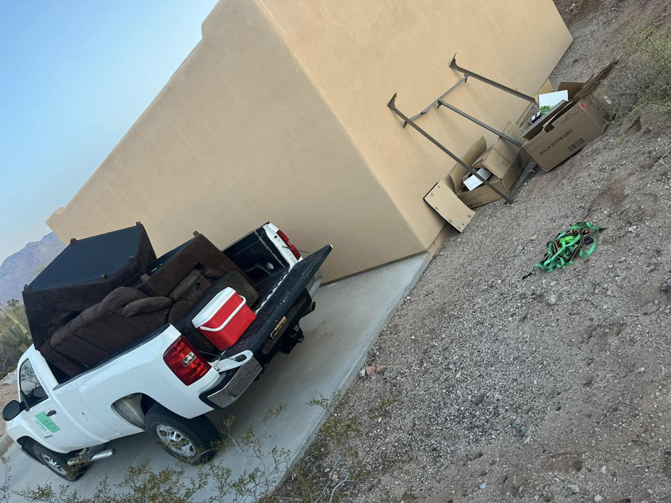 A Better Call Haul truck loaded with furniture and boxes, with more junk on the ground for removal in Funkstown, MD.