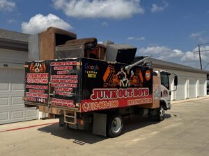 A Junk Out Boyz LLC truck loaded with old furniture and various items after a junk removal job in Georgetown, TX.