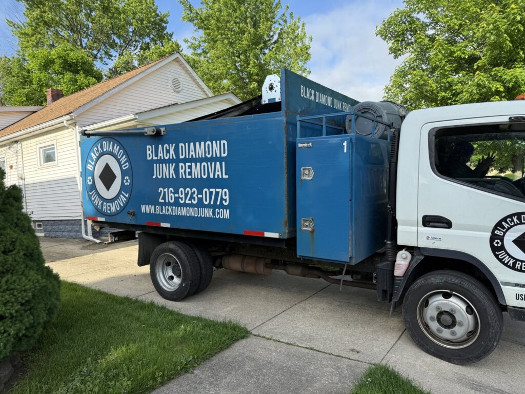 A Black Diamond Junk Removal truck parked at a residential job site in Bedford Heights, OH.