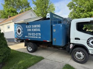 A Black Diamond Junk Removal truck parked at a residential job site in Bedford Heights, OH.