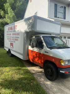 A branded junk removal truck from Total Junk and Bulk Disposal parked in a driveway in Whitsett, NC