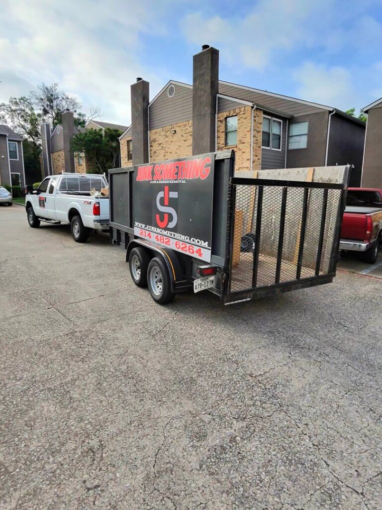Junk Something llc truck and trailer parked in front of a residential home in Dallas, TX.