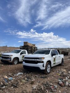 Mora's Junk Removal & Hauling llc. trucks at a landfill or disposal site after a junk removal job in Scottsdale, AZ