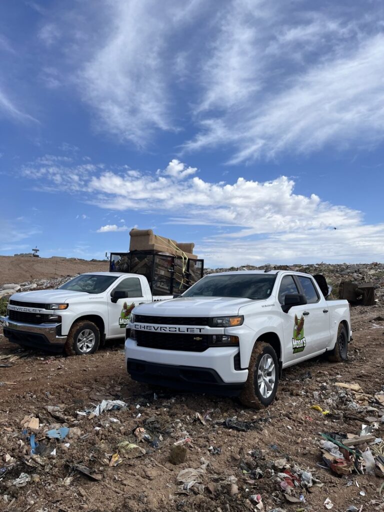 Mora's Junk Removal & Hauling llc. trucks at a landfill or disposal site after a junk removal job in Scottsdale, AZ