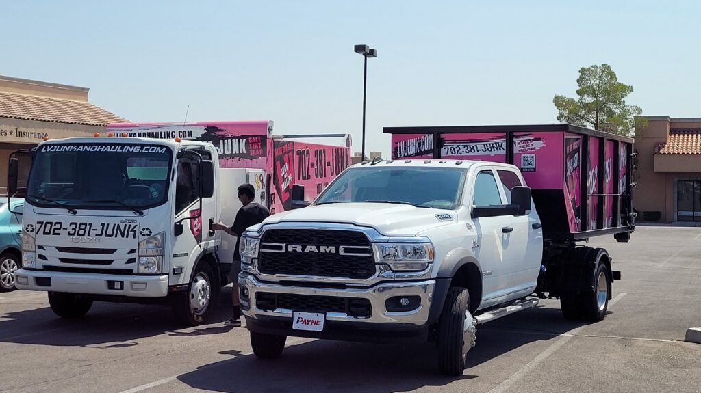 Two branded junk removal trucks from Las Vegas Hauling Junk & Moving parked in Las Vegas, NV