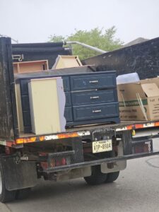 A JunkStart truck loaded with old furniture and boxes, ready for general junk removal in San Antonio, TX.