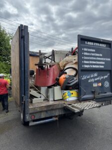 A Junkzilla Inc. truck loaded with various items including furniture and debris, ready for removal in Everett, WA.