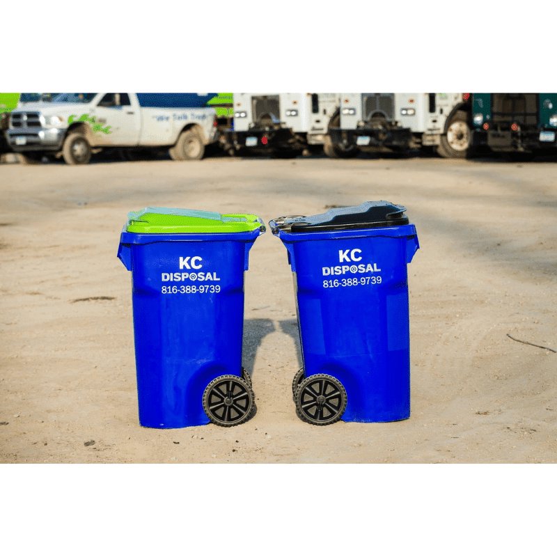 Two blue residential trash bins with KC Disposal branding, ready for collection in Kansas City, KS.