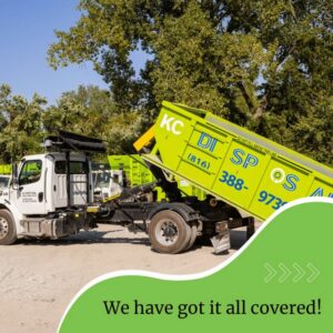 A KC Disposal truck with a roll-off dumpster being loaded or unloaded for junk removal in Kansas City, KS.