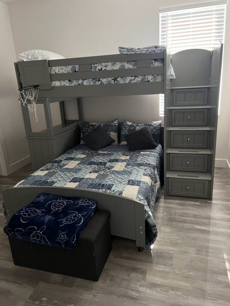 A modern kids' bedroom featuring a bunk bed, designed and built by Coastal Pointe Homes in Tampa, FL.