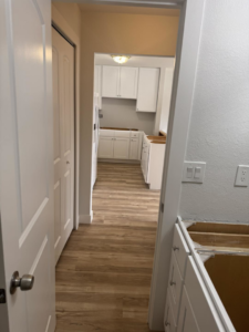 A kitchen and bathroom renovation in progress with new white cabinets installed by Bradford Brothers Builders Inc. in Cape Coral, FL