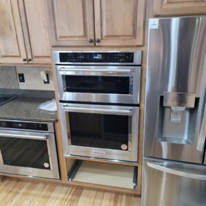 A kitchen featuring newly installed built-in oven, microwave, and refrigerator by Amazing Handyman Services in West Fargo, ND