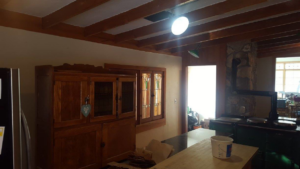 A kitchen or dining area with wooden cabinetry, indicating handyman services by Above & Beyond Painting, LLC in Green Bay, WI.