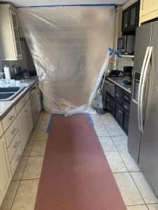 A kitchen area taped off and protected for cabinet painting or refinishing by Considerate Repair in Walla Walla, WA.