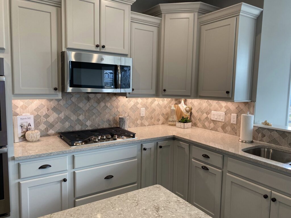A renovated kitchen featuring new backsplash tile, updated cabinets, and countertops by Clear Choice Handyman LLC in Woodbury, MN.