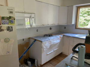 Preparing kitchen countertops and installing a new backsplash during a remodel by Berg Handyman Services in Post Falls, ID