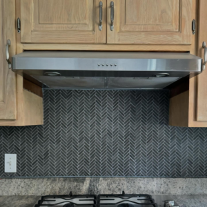 Completed kitchen backsplash and range hood installation by crystalwoodfloors in Port Jervis, NY