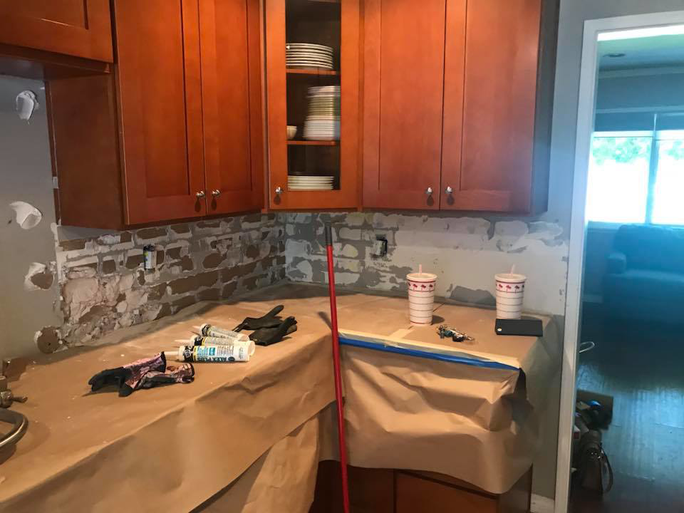 Kitchen counter with old backsplash removed and wall prepared for new tiles by Johnson Handyman Services in Anderson, SC.