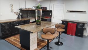 A newly renovated kitchen and bar area with dark cabinets, a large island, and a red mini-fridge, completed by Huff Consolidated Enterprises LLC in Clarksville, TN.