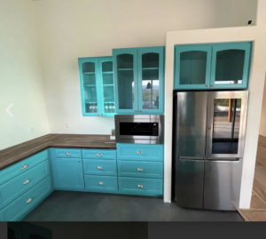 Modern kitchen featuring bright blue cabinets and wooden countertops installed by Arizona Cabinet & Countertop Company in Tucson, AZ.