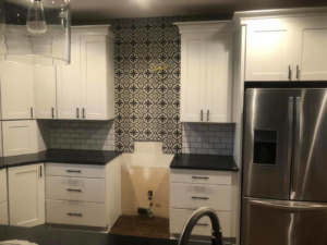 New kitchen cabinets, countertops, and backsplash installed by EXCEL Handyman in Raytown, MO.