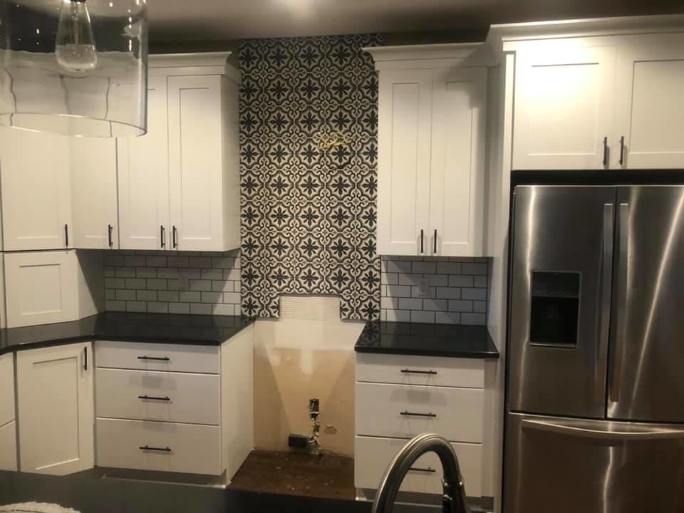 New kitchen cabinets, countertops, and backsplash installed by EXCEL Handyman in Raytown, MO.