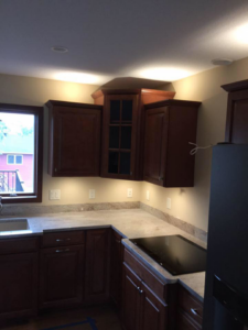 A newly renovated kitchen featuring modern cabinets and under-cabinet lighting installed by NU Current Electric Inc in New Ulm, MN.