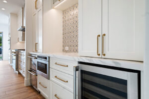 Custom kitchen cabinets with built-in appliances and decorative backsplash installed by Ignite Construction in Tempe, AZ.