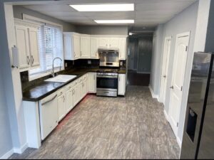 A newly renovated kitchen with white cabinets and stainless steel appliances by L12 Construction LLC in Oshkosh, WI.