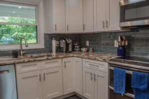 New kitchen cabinets, countertops, and backsplash installed by Cabido Design, a handyman in Brentwood, MD.