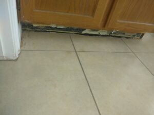Kitchen cabinet base repair and tile flooring work by Shane's Handyman Service in Edmond, OK.