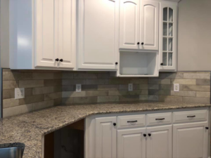 Kitchen with new cabinets, countertops, and tiled backsplash installed by Stapleford Flooring LLC in Milford, DE.