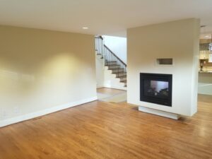 A renovated kitchen with white cabinets and granite countertops, a handyman service by Brush N' Roll Painting Co. in Federal Way, WA.