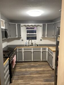 Newly renovated kitchen with gray cabinets and new countertops by Iron Horse Handyman Services LLC in Laramie, WY.