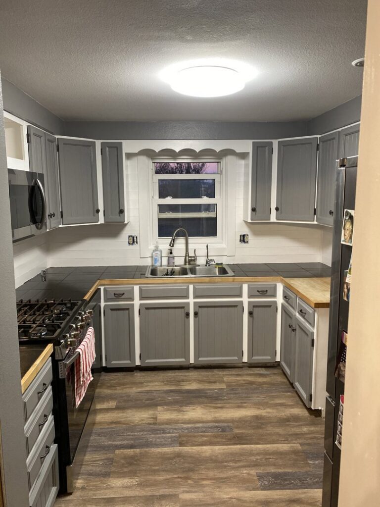 Newly renovated kitchen with gray cabinets and new countertops by Iron Horse Handyman Services LLC in Laramie, WY.