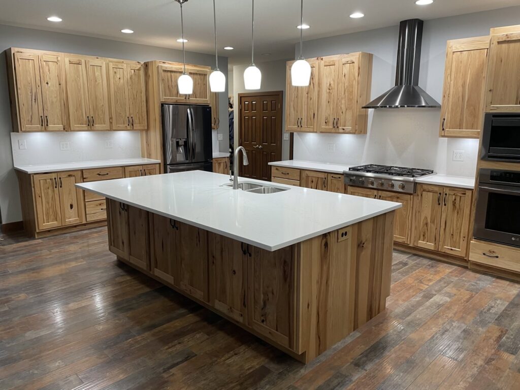 Kitchen featuring new light wood cabinets and white countertops installed by J and R Granite Industry in Columbus, OH.