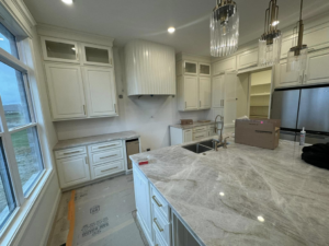 Kitchen cabinets and countertops being installed during a home renovation by Rave Homes - Missouri in Columbia, MO.