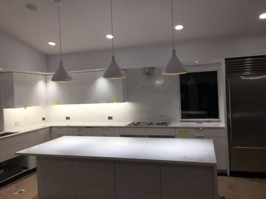 Kitchen cabinet, countertop, and lighting installation in progress by Art of Stone Shop in Bridgeport, CT.