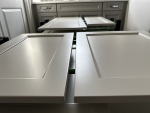 Kitchen cabinet doors prepped and laid out for painting by Sherwood Painting Services in Mooresville, NC.